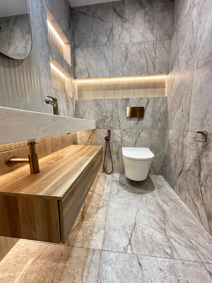 Floating vanity with integrated lighting and recessed shelves