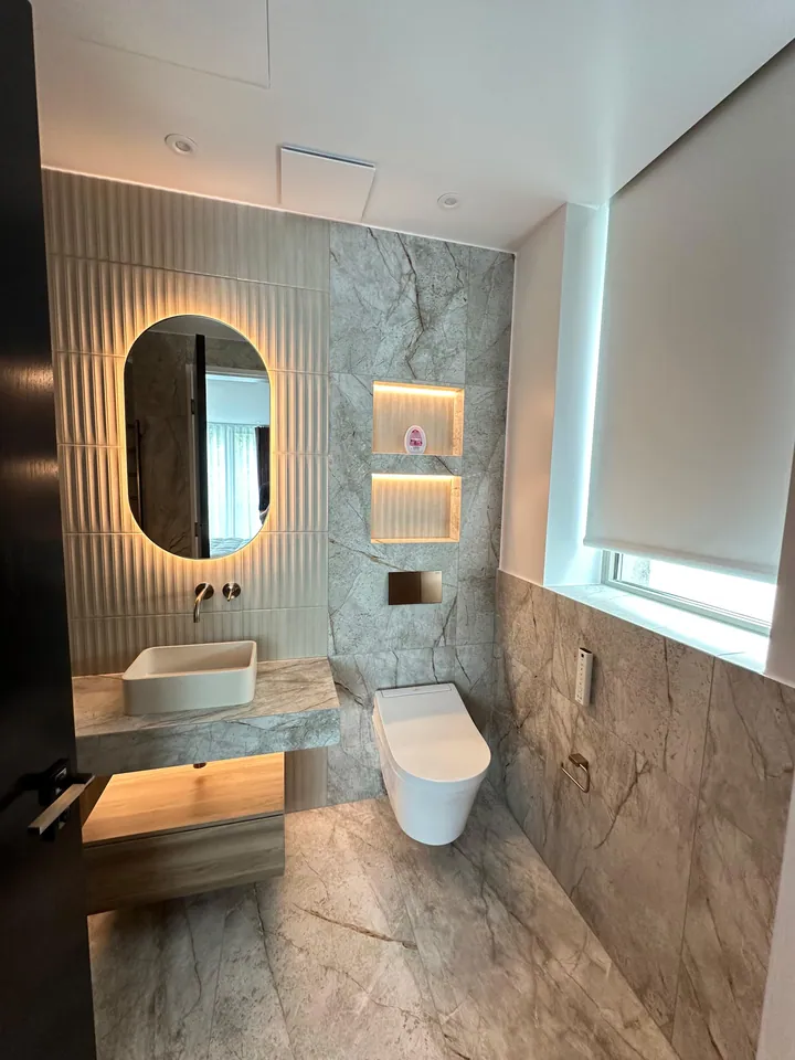 Floating vanity and warm illuminated niches