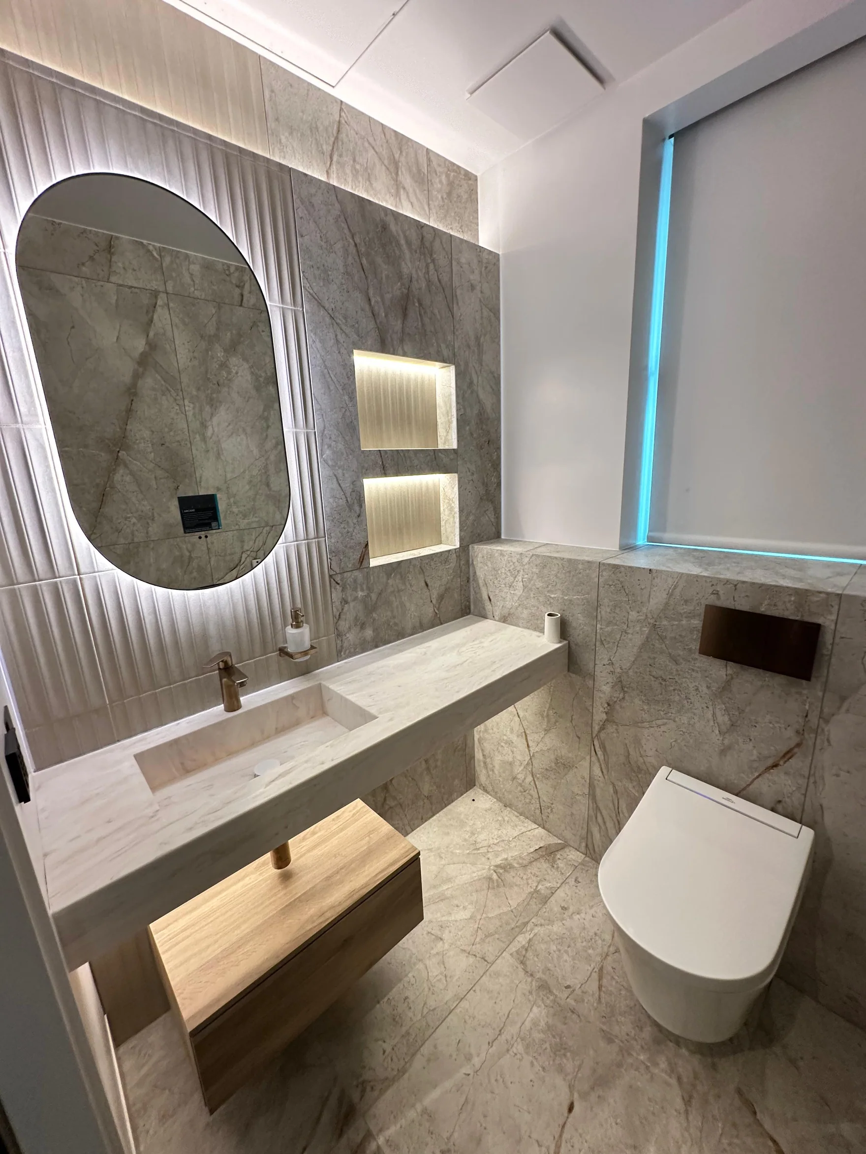 Round mirror and recessed wall lighting