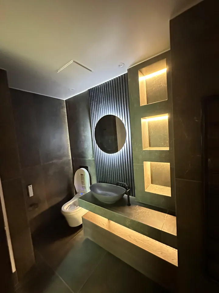 Dark-toned bathroom with warm accent lighting
