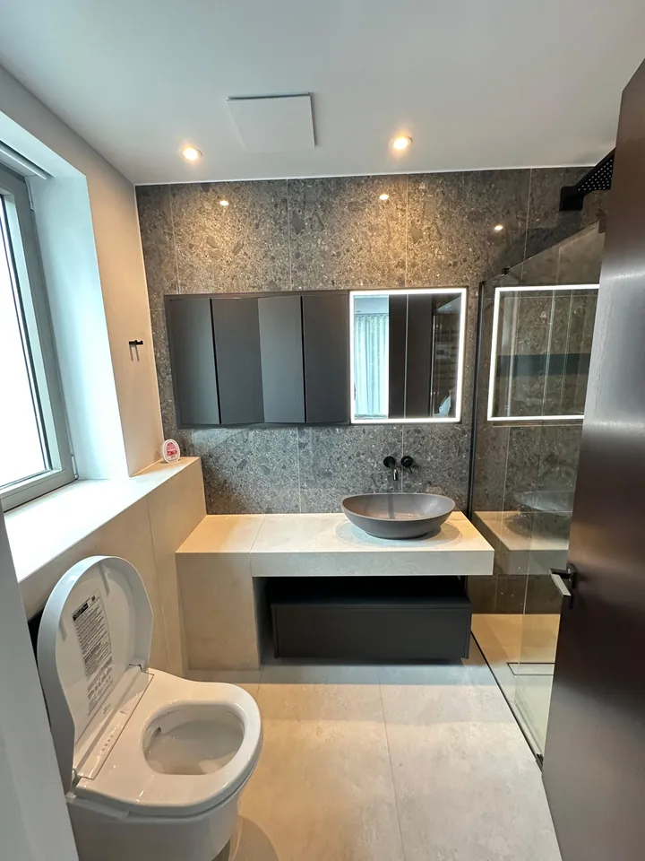 Stone-look bathroom with suspended vanity