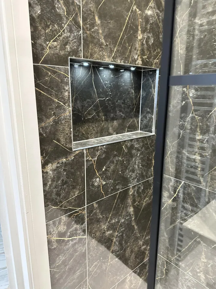 Shower area with dark stone-look tiles